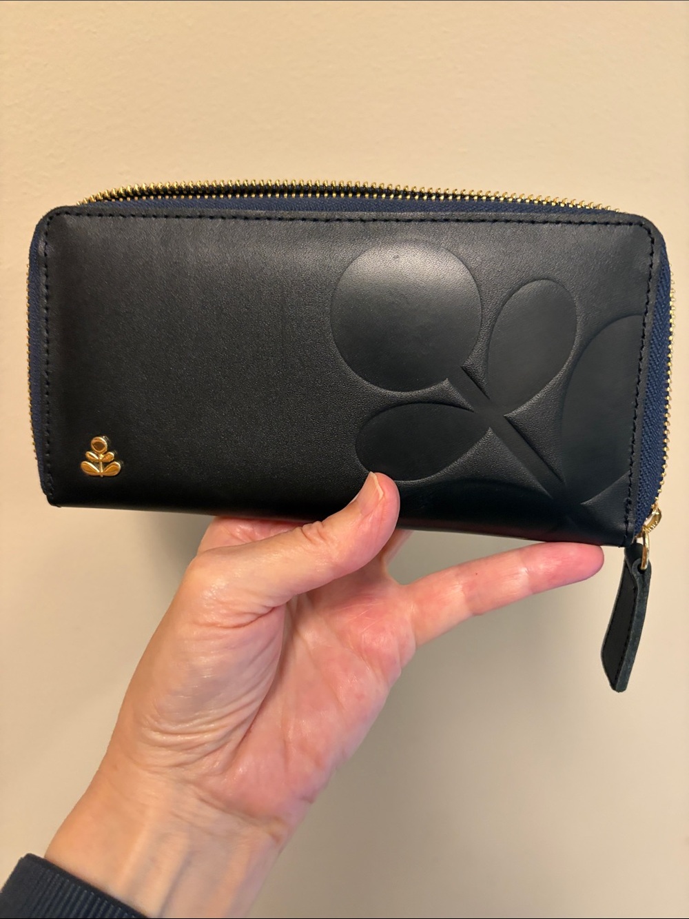 Orla Liely black embossed leather zip-around wallet with gold logo